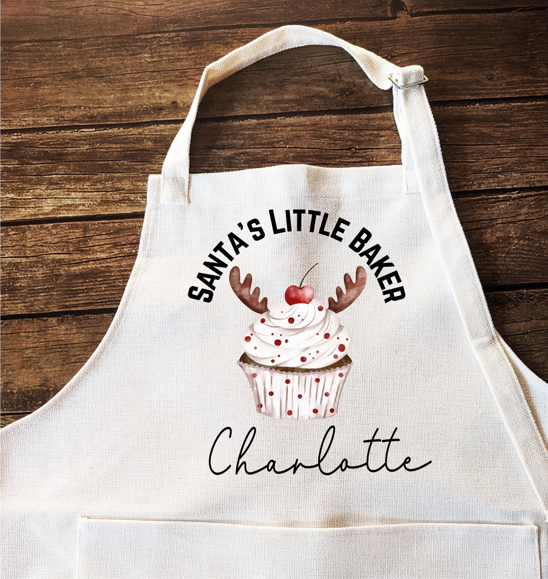 Personalized Kids Christmas Apron – “Santa’s Little Baker” Custom Name Apron with Reindeer Cupcake, Holiday Baking Gift for Children