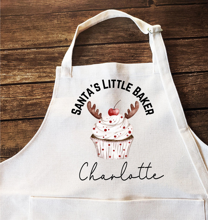 Personalized Kids Christmas Apron – “Santa’s Little Baker” Custom Name Apron with Reindeer Cupcake, Holiday Baking Gift for Children