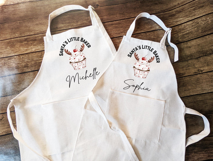 Personalized Kids Christmas Apron – “Santa’s Little Baker” Custom Name Apron with Reindeer Cupcake, Holiday Baking Gift for Children