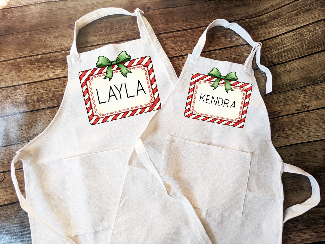 Personalized Kids Christmas Apron – Custom Candy Cane Apron with Name and Green Bow, Festive Baking Gift for Holiday Cookie Parties